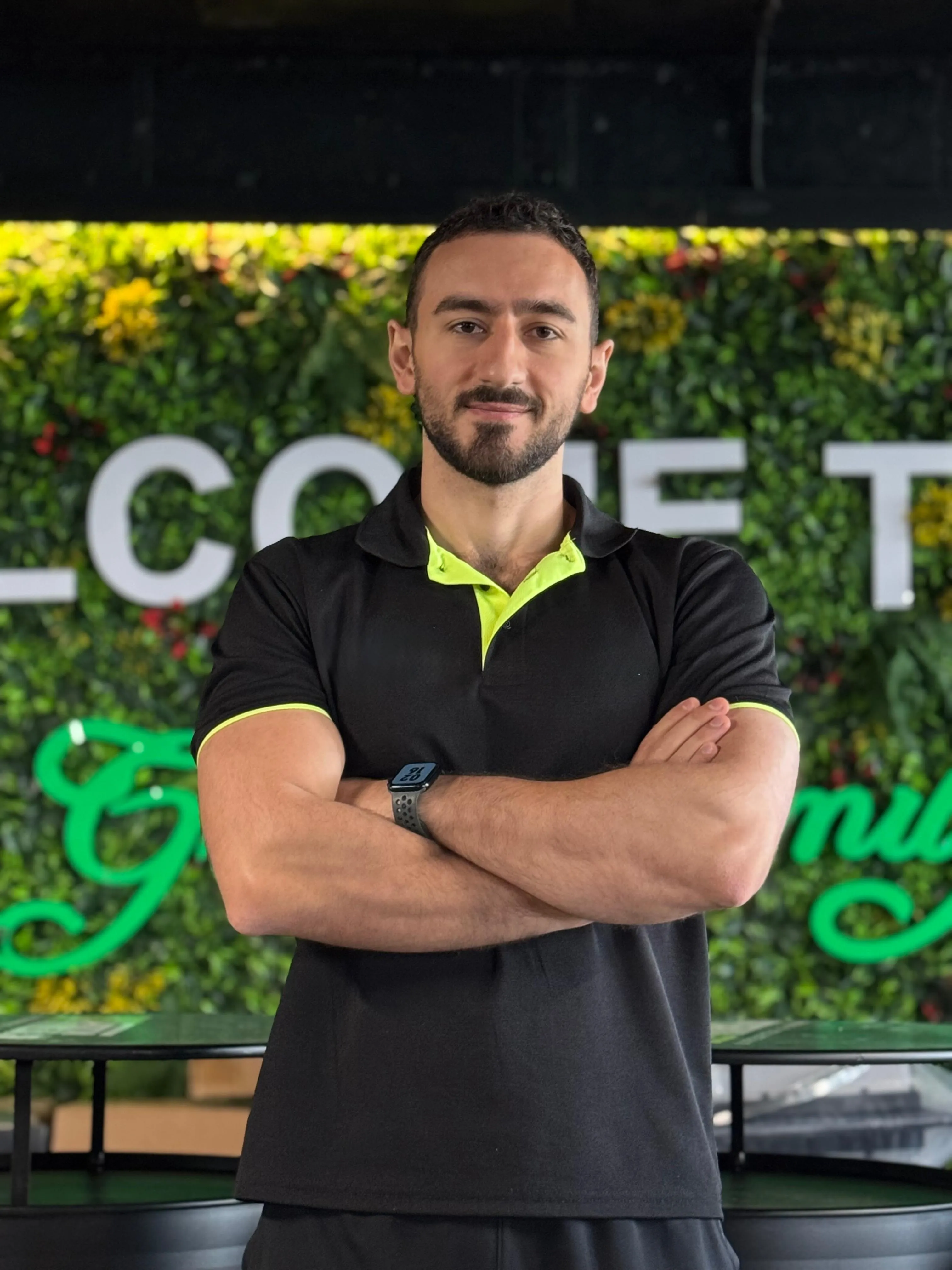 David, sports massage therapist and biomechanics specialist, standing with arms crossed in his gym